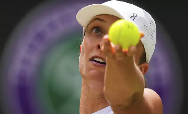 Iga Swiatek of Poland serves to Liudmilla Samsonova of Russia during the women's singles quarter final match at the Wimbledon Tennis Championships in London, Wednesday, July 9, 2025.(AP Photo/Kirsty Wigglesworth)