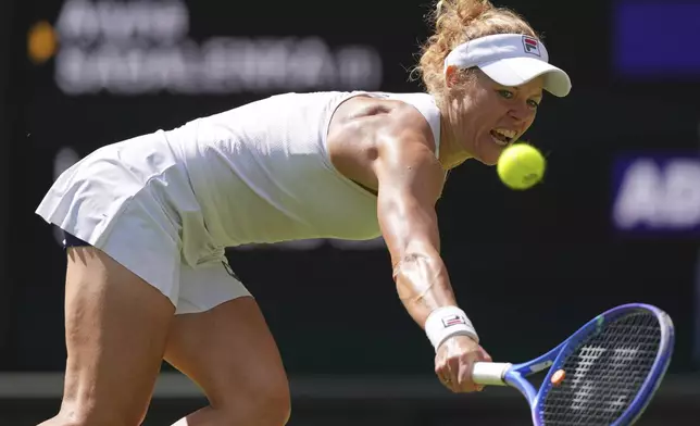 Laura Siegemund of Germany returns to Aryana Sabalenka of Belarus during a quarterfinal women's singles match at the Wimbledon Tennis Championships in London, Tuesday, July 8, 2025. (AP Photo/Kirsty Wigglesworth)