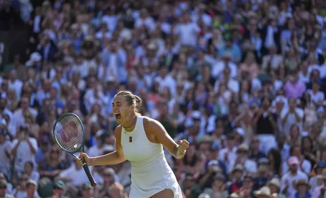 Aryana Sabalenka of Belarus celebrates after beating Laura Siegemund of Germany to win a quarterfinal women's singles match at the Wimbledon Tennis Championships in London, Tuesday, July 8, 2025. (AP Photo/Kirsty Wigglesworth)