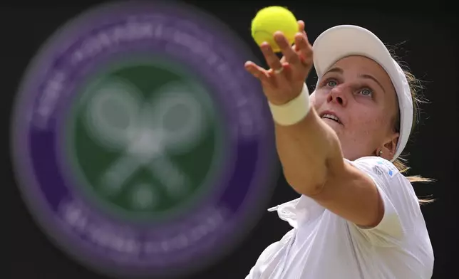 Liudmilla Samsonova of Russia serves the ball to Iga Swiatek of Poland during the women's singles quarter final match at the Wimbledon Tennis Championships in London, Wednesday, July 9, 2025.(AP Photo/Kirsty Wigglesworth)
