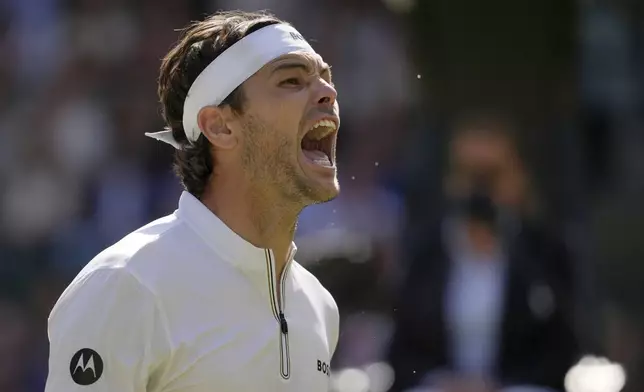 Taylor Fritz of the U.S. celebrates winning the men's singles quarter final match against Karen Khachanov of Russia at the Wimbledon Tennis Championships in London, Tuesday, July 8, 2025.(AP Photo/Kin Cheung)