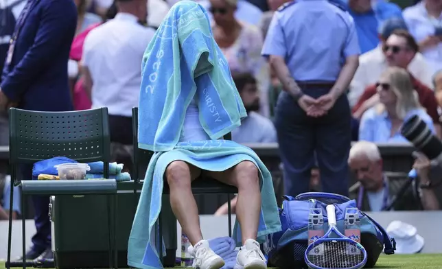 Laura Siegemund of Germany sits in her chair as Aryna Sabalenka of Belarus goes for a break during a quarterfinal women's singles match at the Wimbledon Tennis Championships in London, Tuesday, July 8, 2025. (AP Photo/Kirsty Wigglesworth)