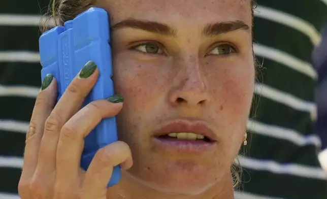Aryana Sabalenka of Belarus tries to keep cool using an ice pack during a change of ends break as she plays Laura Siegemund of Germany during a quarterfinal women's singles match at the Wimbledon Tennis Championships in London, Tuesday, July 8, 2025. (AP Photo/Kirsty Wigglesworth)