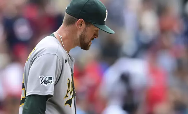 Athletics starting pitcher Jeffrey Springs reacts after a three RBI double by Cleveland Guardians' David Fry during the fourth inning of a baseball game, Sunday, July 20, 2025, in Cleveland. (AP Photo/David Dermer)