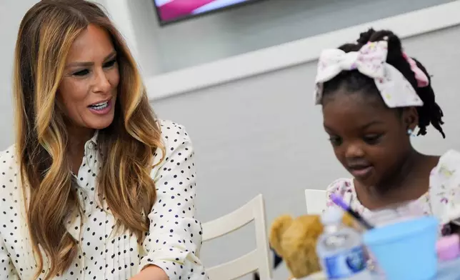 First lady Melania Trump talks with a girl while visiting Children's National Hospital, Thursday, July 3, 2025, in Washington. (AP Photo/Julia Demaree Nikhinson)
