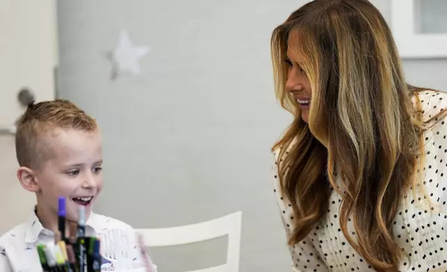 First lady Melania Trump talks with a boy while visiting Children's National Hospital, Thursday, July 3, 2025, in Washington. (AP Photo/Julia Demaree Nikhinson)