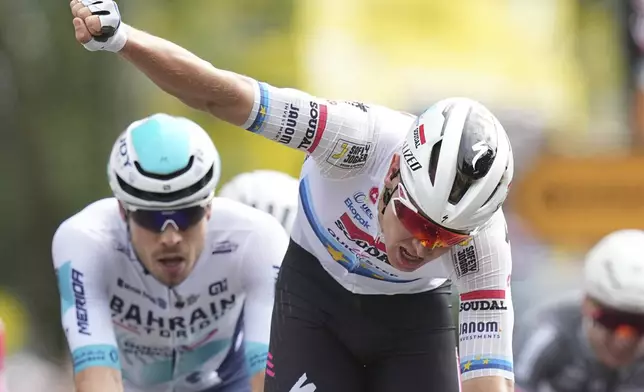 Belgium's Tim Merlier celebrates as he crosses the finish line to win the third stage of the Tour de France cycling race over 178.3 kilometers (110.8 miles) with start in Valenciennes and finish in Dunkerque, France, Monday, July 7, 2025. (AP Photo/Thibault Camus)