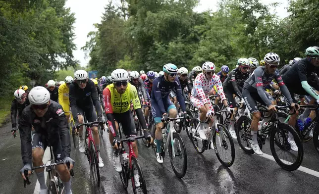 The pack with Slovenia's Tadej Pogacar wearing the best climber's dotted jersey rides during the third stage of the Tour de France cycling race over 178.3 kilometers (110.8 miles) with start in Valenciennes and finish in Dunkerque, France, Monday, July 7, 2025. (AP Photo/Mosa'ab Elshamy)