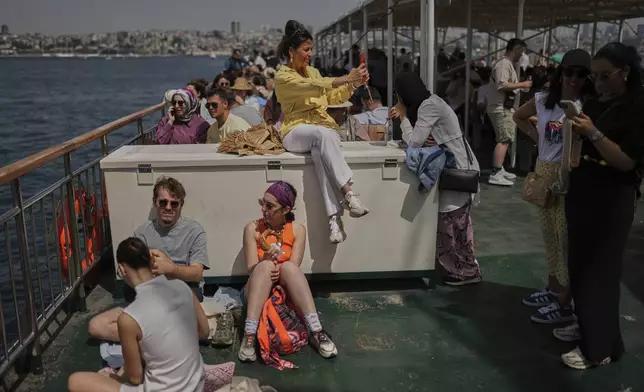 Locals and tourists take a ferry bound for the Princes' Islands in the Sea of Marmara, in Istanbul, Turkey, Saturday, May 24, 2025. (AP Photo/Francisco Seco)