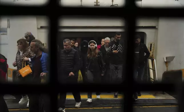 Commuters arrive at the Kadikoy ferry terminal on the Asian side of Istanbul, Turkey, Monday, May 26, 2025. (AP Photo/Francisco Seco)
