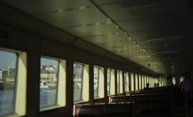 Passengers ride a ferry bound for Kadikoy on the Asian side of Istanbul, Turkey, Thursday, May 22, 2025. (AP Photo/Francisco Seco)