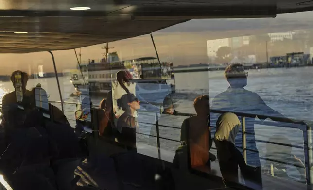 Passengers ride a ferry crossing the Bosphorus in Istanbul, Turkey, Tuesday, May 27, 2025. (AP Photo/Francisco Seco)