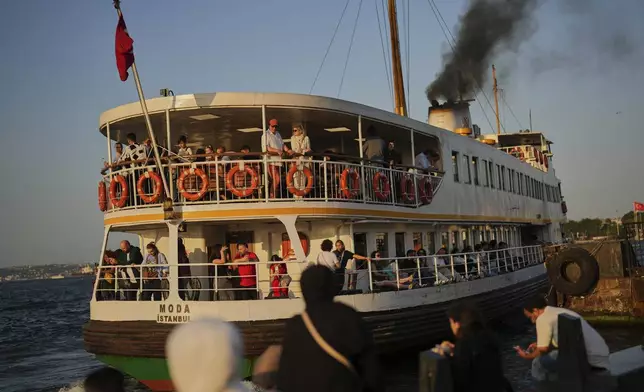 A ferry departs from the Eminonu terminal on the Golden Horn in Istanbul, Turkey, Friday, June 13, 2025. (AP Photo/Francisco Seco)