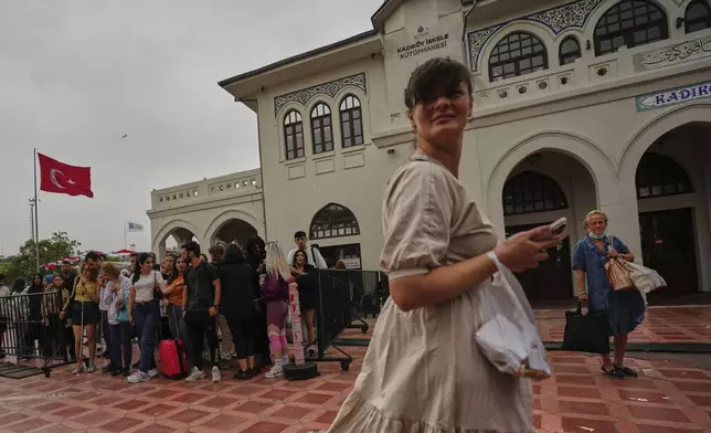Passengers wait to board a ferry at the Kadikoy terminal on the Asian side of Istanbul, Turkey, Sunday, May 25, 2025. (AP Photo/Francisco Seco)