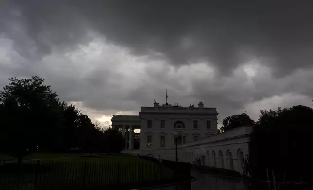 Dark clouds hover over the White House as a front of rain moves through, Monday, July 14, 2025, in Washington. (AP Photo/Alex Brandon)