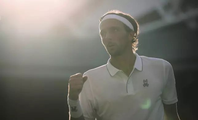 Arthur Rinderknech of France reacts after wining a point against Alexander Zverev of Germany in their first round men's singles match at the Wimbledon Tennis Championships in London, Tuesday, July 1, 2025. (AP Photo/Kin Cheung)