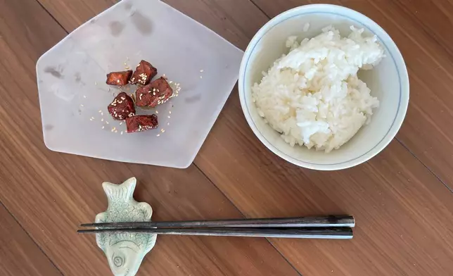 A plate of tuna tsukudani, served with hot rice, appears in the Tsukuda neighborhood of Tokyo, Monday, June 30, 2025. (AP Photo/Yuri Kageyama)