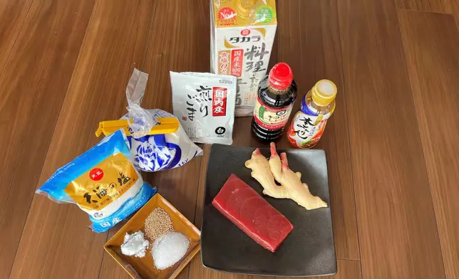 Ingredients for tsukudani, a Japanese preserved food, made with tuna, soy sauce, mirin, sake, sugar and salt, are displayed in the Tsukuda neighborhood of Tokyo on Monday, June 30, 2025. (AP Photo/Yuri Kageyama)