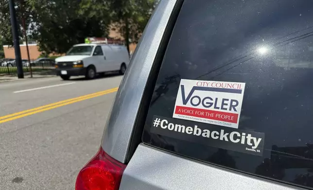 A bumper sticker outside the offices of Showcase Magazine in Danville, Va., where city Councilmember Lee Vogler was attacked and set on fire, is seen on Wednesday, July 30, 2025. (AP Photo/Allen G. Breed)