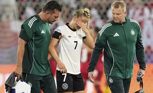 Germany's Giulia Gwinn leaves the pitch after getting injured during the Euro 2025, group C, soccer match between Germany and Poland at Arena St. Gallen in St. Gallen, Switzerland, Friday, July 4, 2025. (AP Photo/Martin Meissner)