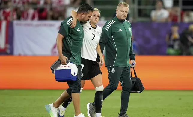 Germany's Giulia Gwinn leaves the pitch after getting injured during the Euro 2025, group C, soccer match between Germany and Poland at Arena St. Gallen in St. Gallen, Switzerland, Friday, July 4, 2025. (AP Photo/Martin Meissner)