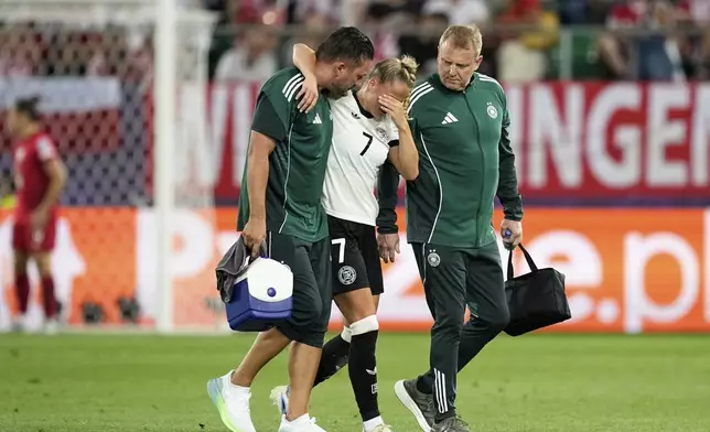 Germany's Giulia Gwinn leaves the pitch after getting injured during the Euro 2025, group C, soccer match between Germany and Poland at Arena St. Gallen in St. Gallen, Switzerland, Friday, July 4, 2025. (AP Photo/Martin Meissner)