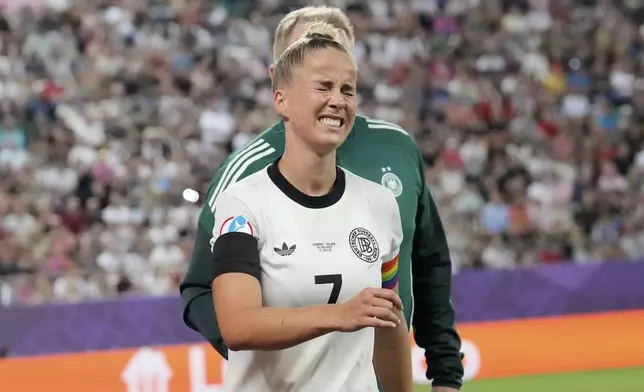 Germany's Giulia Gwinn grimaces after getting injured during the Euro 2025, group C, soccer match between Germany and Poland at Arena St. Gallen in St. Gallen, Switzerland, Friday, July 4, 2025. (AP Photo/Martin Meissner)