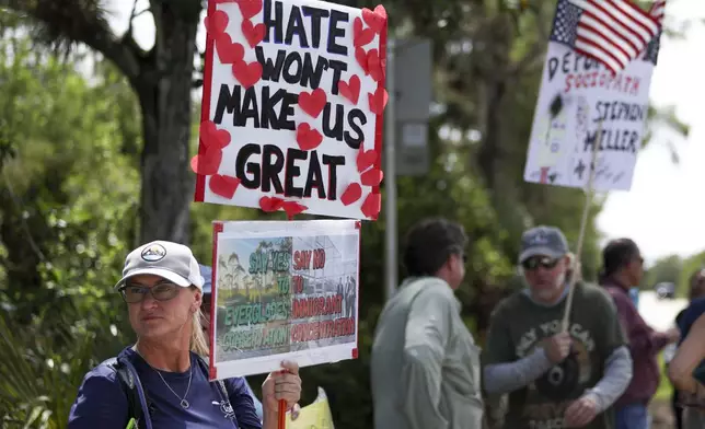 A protester stands outside the migrant detention facility dubbed "Alligator Alcatraz" at the Dade-Collier Training and Transition Facility, Saturday, July 12, 2025, in Ochopee, Fla. (AP Photo/Alexandra Rodriguez)