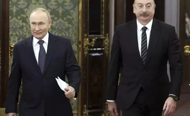 FILE - Russian President Vladimir Putin, left, and Azerbaijani President Ilham Aliyev enter a hall during a meeting at the Kremlin in Moscow, Russia, Oct. 8, 2024. (Valery Sharifulin, Sputnik, Kremlin Pool Photo via AP, File)