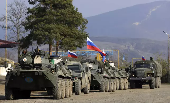 FILE - Vehicles used by Russian peacekeepers are seen parked at a checkpoint on the road in the region of Karabakh in the South Caucasus, Nov. 17, 2020. (AP Photo/Sergei Grits, File)