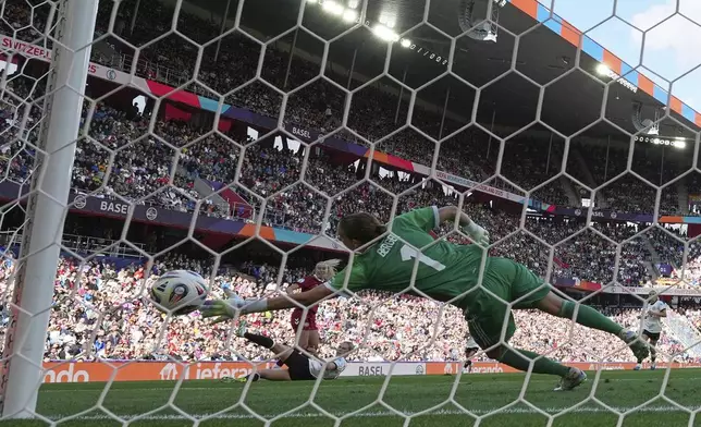 Germany goalkeeper Ann-Katrin Berger fails to save the goal from Denmark's Amalie Vangsgaard, left, during the Euro 2025, group C, soccer match between Germany and Denmark at St. Jakob-Park in Basel, Switzerland, Tuesday, July 8, 2025. (AP Photo/Martin Meissner)