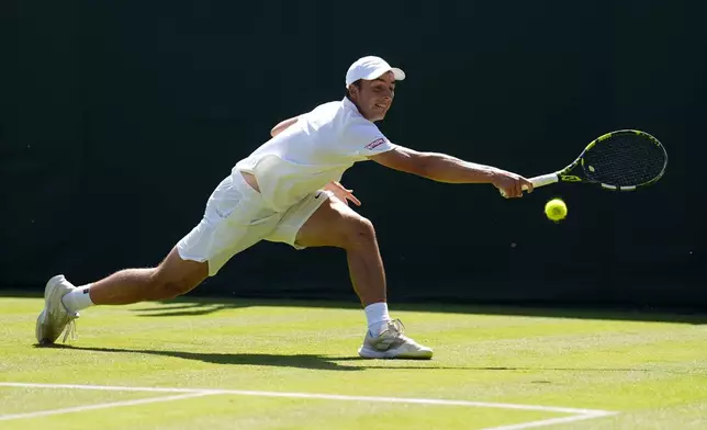 Britain's Oliver Tarvet in action during his match against Switzerland's Leandro Riedi in their first round men’s singles match at the Wimbledon Tennis Championships in London, Monday, June 30, 2025. ( Jordan Pettitt/PA via AP)