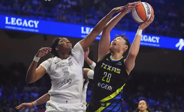 Las Vegas Aces forward NaLyssa Smith (3) defends the basket against Dallas Wings center Li Yueru (28) during the first half of a WNBA basketball game in Arlington, Texas, Sunday, July 27, 2025. (AP Photo/LM Otero)