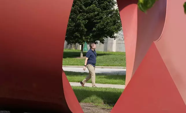 A guest walks on the campus of Indiana University, Thursday, July 17, 2025, in Bloomington, Ind. (AP Photo/Darron Cummings)