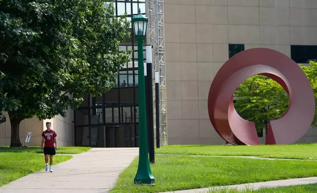 A guest walks on the campus of Indiana University, Thursday, July 17, 2025, in Bloomington, Ind. (AP Photo/Darron Cummings)