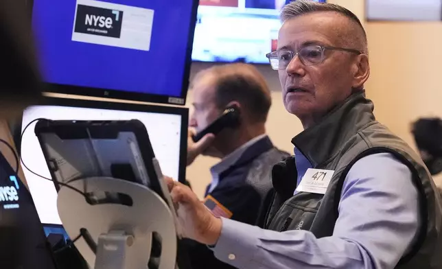 Trader Neil Catania works on the floor of the New York Stock Exchange, Tuesday, July 1, 2025. (AP Photo/Richard Drew)