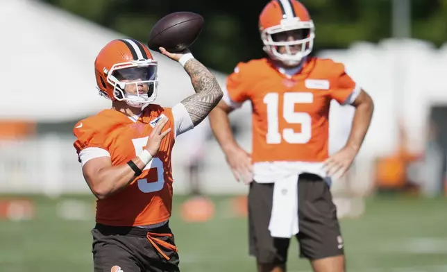 Cleveland Browns quarterback Dillon Gabriel (5) throws in front of quarterback Joe Flacco (15) during a practice at the team's NFL football training camp Wednesday, July 23, 2025, in Berea, Ohio. (AP Photo/Sue Ogrocki)