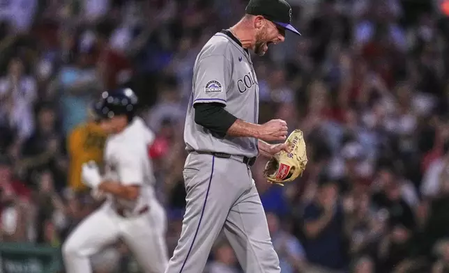 Colorado Rockies pitcher Austin Gomber, right, reacts as Boston Red Sox's Roman Anthony, back left, rounds the bases on a two-run home run during the fifth inning of a baseball game at Fenway Park, Monday, July 7, 2025, in Boston. (AP Photo/Charles Krupa)
