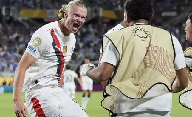 Manchester City's Erling Haaland, left, celebrates after scoring his team's second goal during the Club World Cup round of 16 soccer match between Manchester City and Al Hilal in Orlando, Fla., Monday, June 30, 2025. (AP Photo/John Raoux)