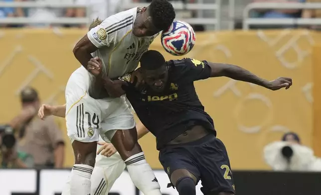 Real Madrid's Aurelien Tchouameni, left, and Juventus' Randal Kolo Muani battle for a head ball during the Club World Cup round of 16 soccer match between Real Madrid and Juventus in Miami Gardens, Fla., Tuesday, July 1, 2025. (AP Photo/Lynne Sladky)