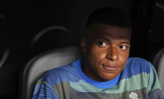 Real Madrid's Kylian Mbappe sits on the bench before the Club World Cup round of 16 soccer match between Real Madrid and Juventus in Miami Gardens, Fla., Tuesday, July 1, 2025. (AP Photo/Rebecca Blackwell)