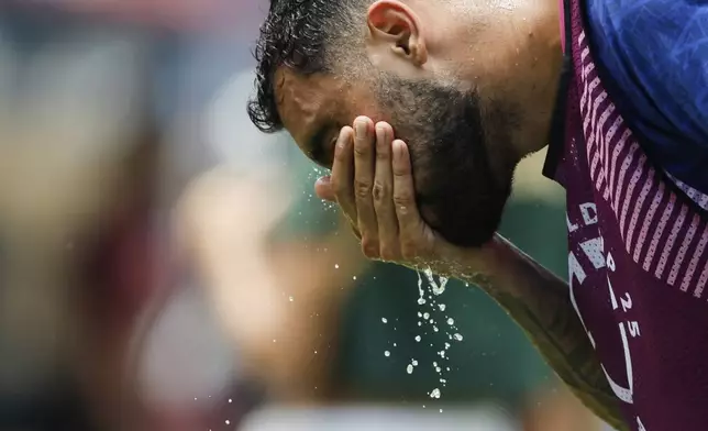 Fluminense's Juan Pablo Freytes (22) cools off as he warms up before the Club World Cup round of 16 soccer match between Inter Milan and Fluminense in Charlotte, N.C., Monday, June 30, 2025. (AP Photo/Nell Redmond)