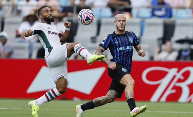 Fluminense's Samuel Xavier (2) plays the ball in front of Inter Milan's Federico Dimarco (32) during the Club World Cup round of 16 soccer match between Inter Milan and Fluminense in Charlotte, N.C., Monday, June 30, 2025. (AP Photo/Nell Redmond)