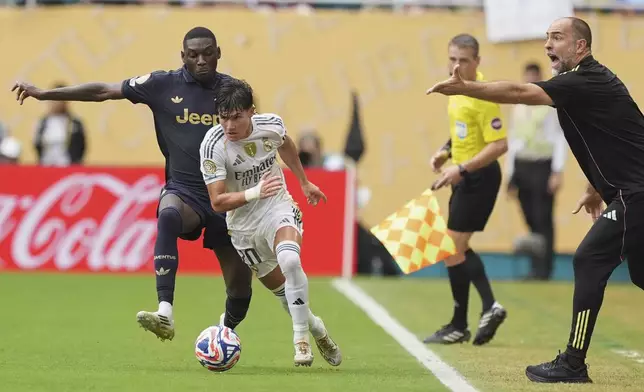 Real Madrid's Fran Garcia, front, and Real Madrid's Fran Garcia fight vor the ball in front of Juventus manager Igor Tudorduring the Club World Cup round of 16 soccer match between Real Madrid and Juventus in Miami Gardens, Fla., Tuesday, July 1, 2025. (AP Photo/Rebecca Blackwell)