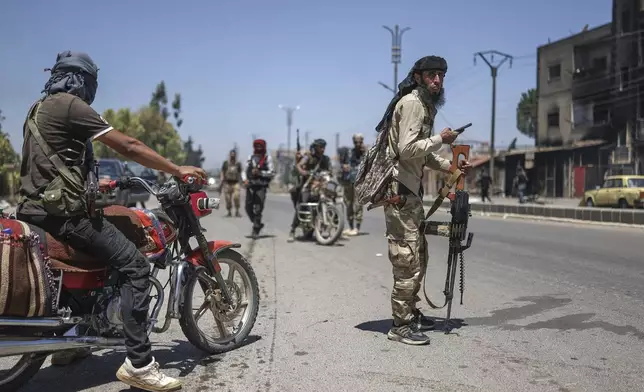 FILE - Bedouin fighters deploy at Mazraa village on the outskirts of Sweida city, during clashes between the Bedouin clans and Druze militias, southern Syria, Friday, July 18, 2025. (AP Photo/Ghaith Alsayed, File)