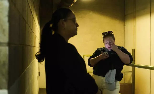 U.S. citizen Christina Jimenez, right, waits for news about her step father originally from Guatemala, who was detained by federal agents, outside the ICE Los Angeles Staging Facility in Los Angeles, on Wednesday, June 25, 2025. (AP Photo/Damian Dovarganes)