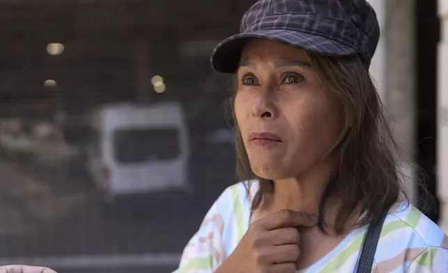 Som Xin, originally from Laos, stands outside the ICE Los Angeles Staging Facility looking to find a family member detained by federal agents in Los Angeles on Wednesday, June 25, 2025. (AP Photo/Damian Dovarganes)