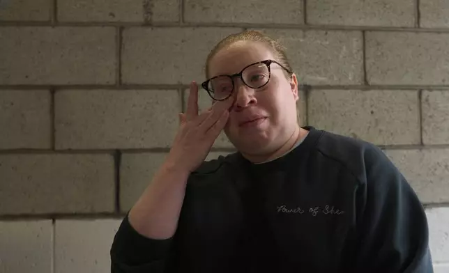 U.S. citizen Christina Jimenez looks for her step father originally from Guatemala, who was detained by federal agents, outside the ICE Los Angeles Staging Facility in Los Angeles, on Wednesday, June 25, 2025. (AP Photo/Damian Dovarganes)