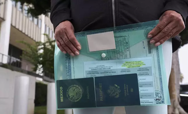 Margarita Velez, mother of Andrea Velez, a U.S. citizen of South L.A, holds to her daughter's current U.S. passport, and her Mexican passport, as she looks for her location, after ICE agents detained Andrea Velez during an immigration raid in downtown, outside the Metropolitan Detention Center in Los Angeles on Wednesday, June 25, 2025. (AP Photo/Damian Dovarganes)