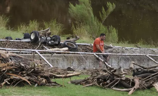 A man surveys debris and flood damage along the Guadalupe River, Sunday, July 13, 2025, in Kerrville, Texas. (AP Photo/Eric Gay)
